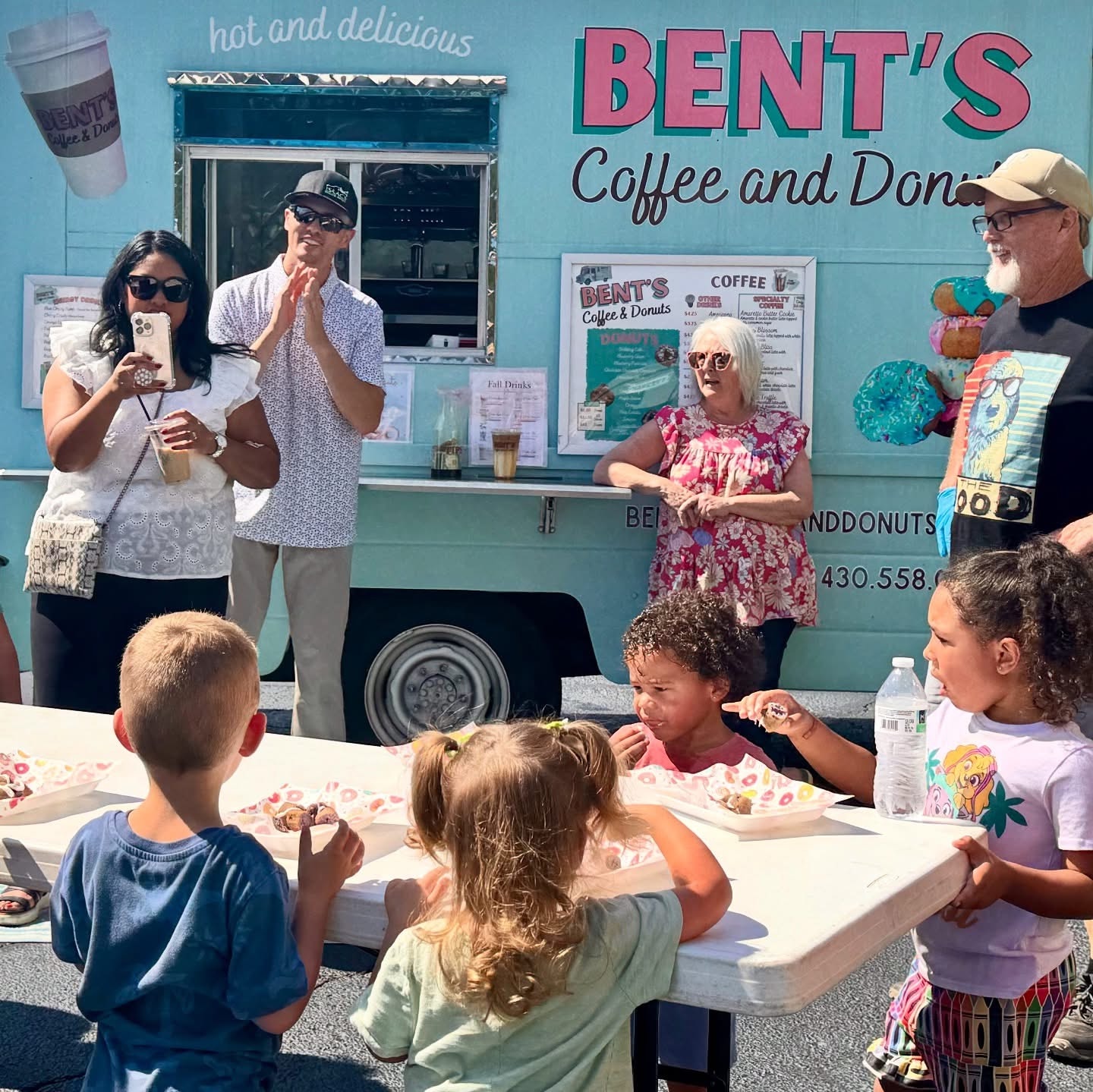 Kids enjoying donuts at Chalk Your HeART Out